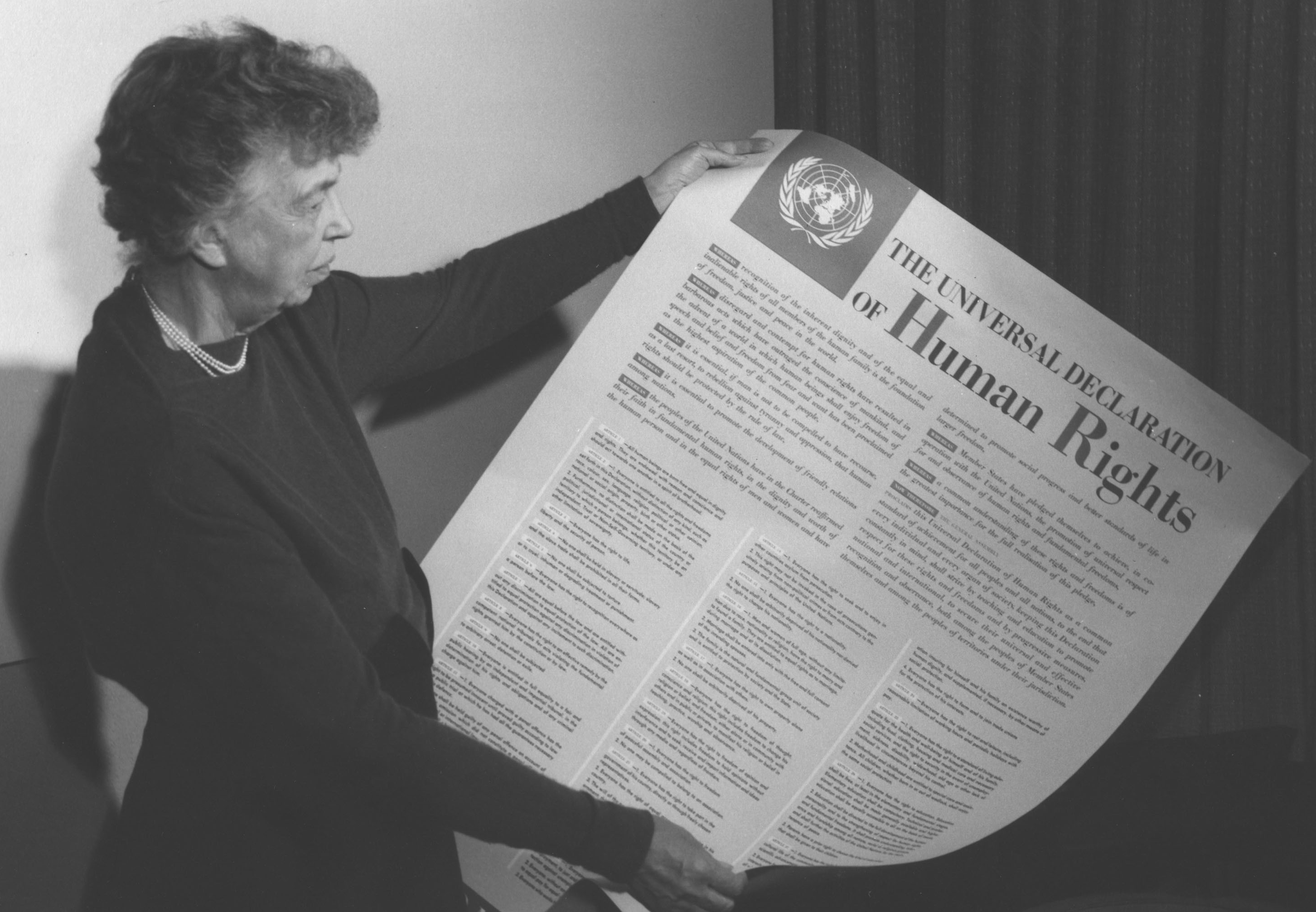 Eleanor Roosevelt holding a printed Universal Declaration of Human Rights